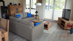 a living room with a couch and a tv at Edith in Lenz