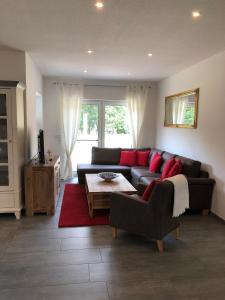 a living room with a black couch and red pillows at Michael in Lenz