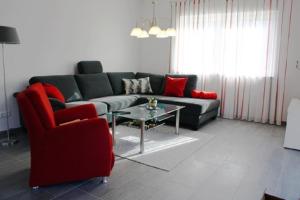 a living room with a couch and a red chair at Valentina in Lenz