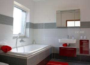 a bathroom with a tub and a sink and a window at Valentina in Lenz +3 photos