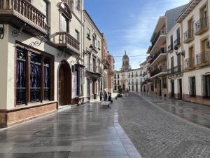an empty street in a city with buildings at Studio Nova in Priego de Córdoba +27 photos