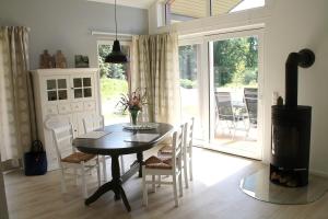 a dining room with a table and chairs and a fireplace at Trine in Lenz