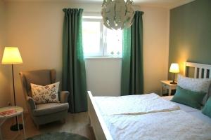 a bedroom with a bed and a chair and a window at Trine in Lenz