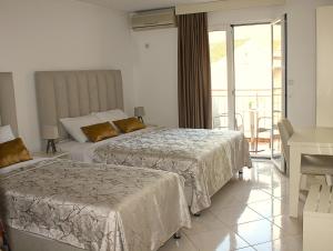 a hotel room with two beds and a balcony at Villa Bojana in Budva +67 photos