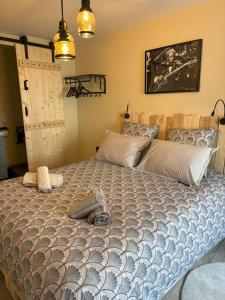 a bedroom with a large bed in a room at Aux 12 instants, Imagine in Lédergues