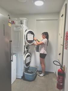 a woman is putting a sign on a refrigerator at Penny's Drop Inn in Cromwell +19 photos