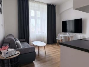 a living room with a couch and a table at Parkány Litoměřice in Litoměřice