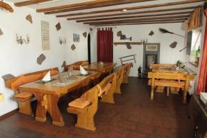 a dining room with wooden tables and chairs at Pension Schiffer in Blankenheim