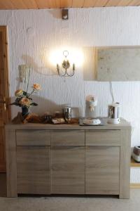 a counter in a kitchen with a light fixture at Pension Schiffer in Blankenheim +4 photos