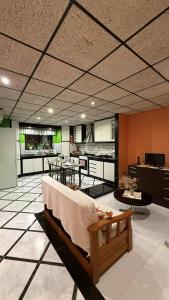 a room with a bed and a kitchen with tables at Flat 3 in Mġarr