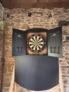 a dart board on a wall with four darts at Aux 12 instants, Imagine in Lédergues