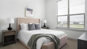 a white bedroom with a bed and a window at Landing Beautiful 2BD Pool Yoga Studio in Austin +37 photos