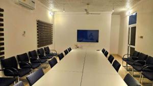 a conference room with a long table and chairs at The Basileia Court in Janman