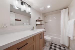 a bathroom with a sink and a tub and a toilet at Cute Cabin with Mountain Views and King Bed in Provo +34 photos