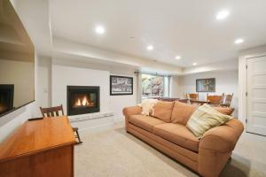a living room with a couch and a fireplace at Cute Cabin with Mountain Views and King Bed in Provo