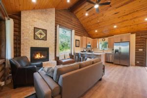a living room with a couch and a fireplace at Cute Cabin with Mountain Views and King Bed in Provo