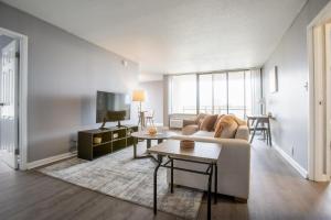 a living room with a couch and a tv at Landing Stylish Studio Gym Game Room in Fort Wayne