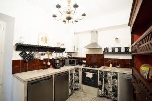 a kitchen with a chandelier hanging from the ceiling at CAR-Volterra Cottage-AN in Carcassonne