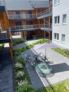 a patio with a table and chairs and an umbrella at Art Apart Stuttgart in Rutesheim
