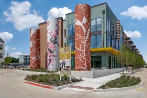 a building with a mural on the side of it at Landing Chic 3BD Clubhouse Pool in Denton