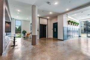 an empty lobby with a column in a building at Landing Chic 3BD Clubhouse Pool in Denton +99 photos
