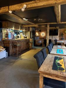 a room with a table and chairs and a bar at The Black Swan Inn in Leominster