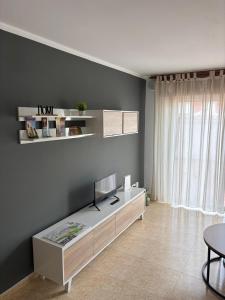 a living room with a bed and a table at Apartamento O SALEIRO in Padrón