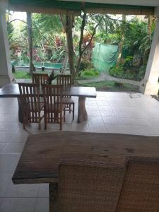 a table and chairs in a patio with a table at Sang Fajar Ubud in Ubud