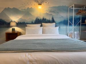 a bedroom with a large bed with a mountain mural at Le Chalet de la Plage in Sévrier