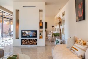 a living room with a fireplace and a couch at VILLA 2s in Marrakesh