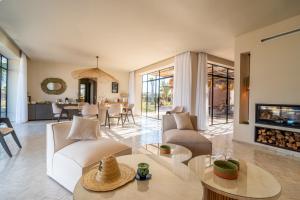 a living room filled with furniture and a fireplace at VILLA 2s in Marrakesh