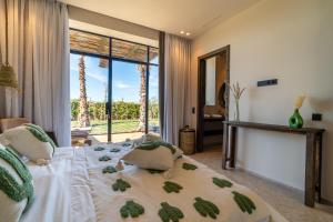 a bedroom with a bed and a large window at VILLA 2s in Marrakesh +42 photos