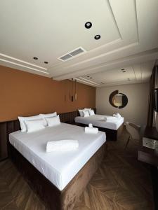 a hotel room with two beds and a mirror at Spa&Hotel Studenac in Trebinje