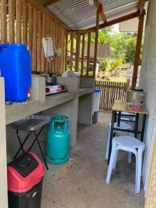 an outdoor kitchen with a table and chairs at L & Ev Be My Guest in San Juan