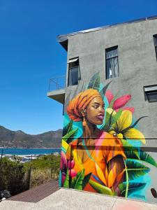 a mural of a woman on the side of a building at Best Place Ever in Hout Bay