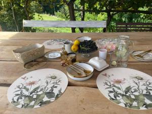 a wooden table with plates of food on it at Hillside Bio Glamping in Prebold