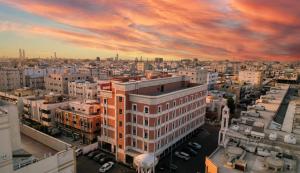 a view of a city with buildings and a sunset at La Richy Jeddah in Jeddah