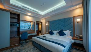 a hotel room with a large bed and a television at La Richy Jeddah in Jeddah +41 photos