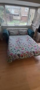 a bed in a bedroom with a floral bedspread at Apartment No 4 in Bridlington