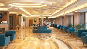 a lobby with blue chairs and a waiting room at La Richy Jeddah in Jeddah