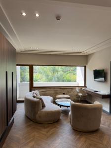 a living room with two chairs and a table at Spa&Hotel Studenac in Trebinje