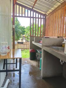 an outdoor kitchen with a sink and a table at L & Ev Be My Guest in San Juan +6 photos