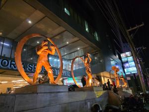 a group of statues in front of a building at Apartment 2 Quezon City Condo Pool View in Manila