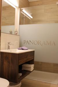 a bathroom with a sink and a sign that reads panoramic at Apartment Panorama in Wagrain