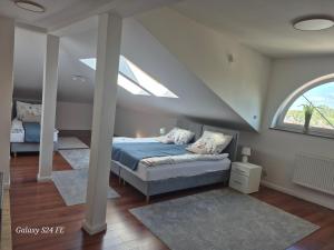 a bedroom with a bed with a large window at Gościniec Chmielnicki in Chmielnik +2 photos