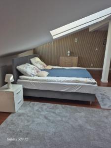 a bedroom with a large bed with blue sheets and pillows at Gościniec Chmielnicki in Chmielnik