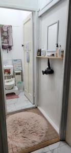 a bathroom with a toilet and a rug at Meyenburg House in Mount Morgan +24 photos