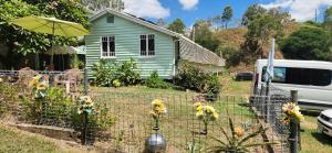 a fence with flowers on it in front of a house at Meyenburg House in Mount Morgan