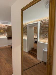 a mirror in a room with a brick wall at RotHaus Old Town Sibiu in Sibiu