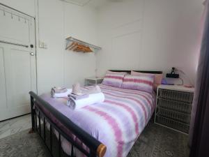 a bedroom with a bed with towels on it at Meyenburg House in Mount Morgan